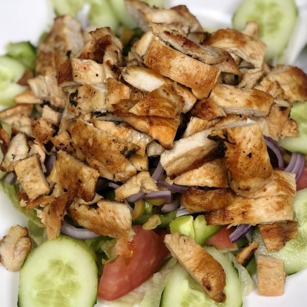 Grilled chicken salad with lettuce, cucumbers, tomatoes, and red onions from Lyndhurst Pizza.